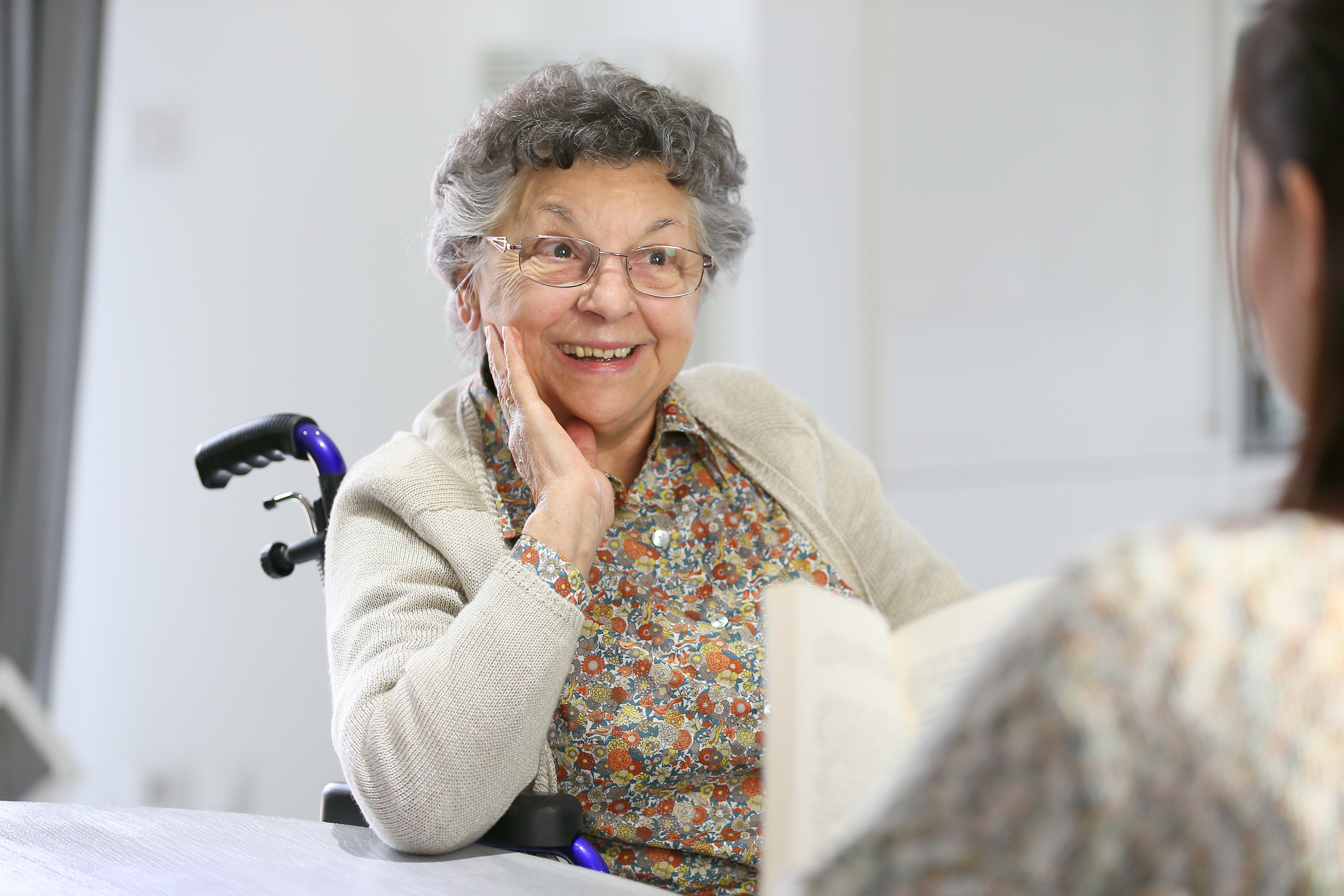 Elderly woman in wheelchair smiling