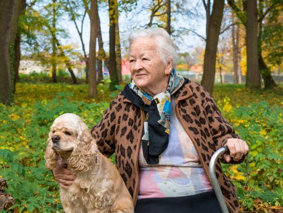 Elderly woman with dog outside