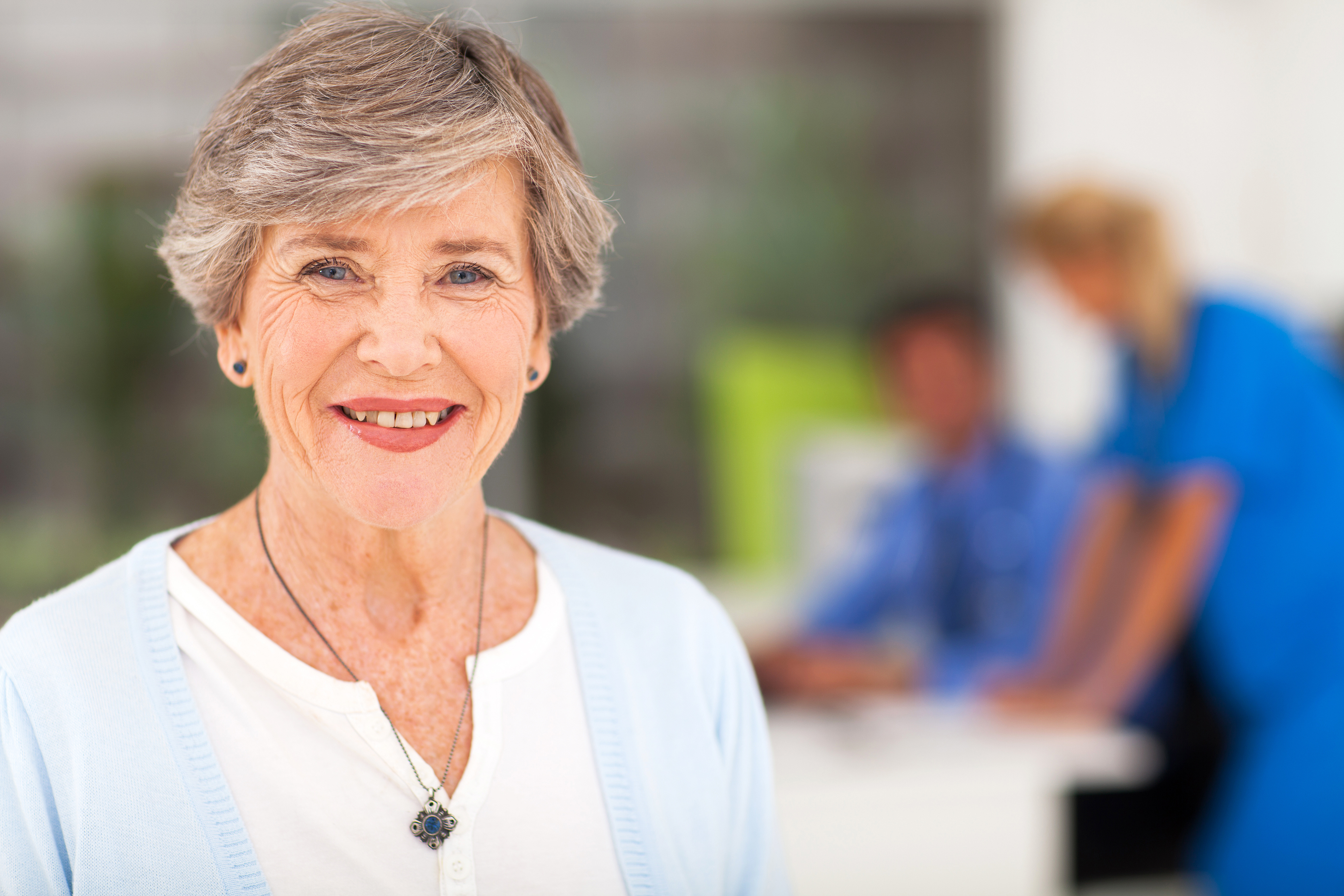 elderly woman with CCaH care team in background