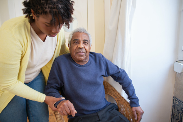 elderly-man-receiving-assistance-from-caregiver.png