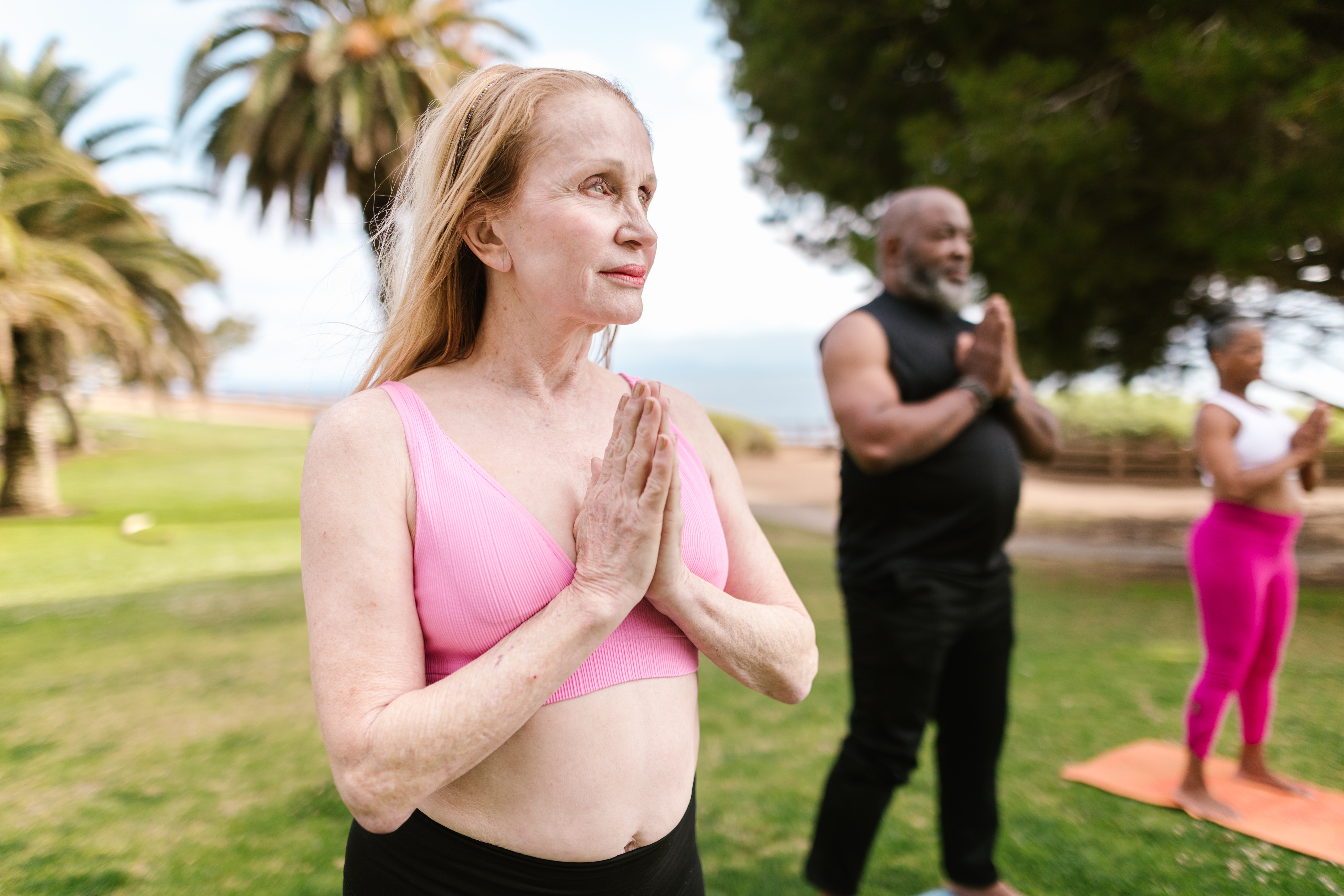 older woman meditating outside